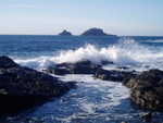 Waves breaking at Priests Cove, Cape Cornwall with The Brisons in distance